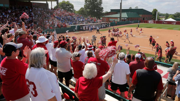 Fans cheer as Crimson Tide players rush the field after Alabama defeated Kentucky 4-1 to advance to the College World Series Saturday Friday, May 29, 2021, in Rhoads Stadium in Tuscaloosa.